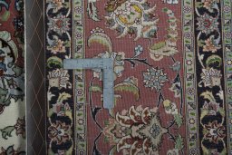 Backside of handmade New Tabriz 50/60/70 Raj rug showing knot structure and weave density
