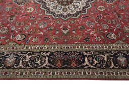 Corner detail of 2000s Tabriz 50/60/70 Raj rug showing border pattern and Cork pile