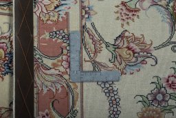 Backside of handmade 2000s Tabriz 50/60/70 Raj rug showing knot structure and weave density