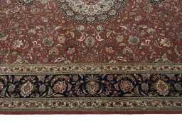 Corner detail of 2000s Tabriz 50/60/70 Raj rug showing border pattern and Cork pile