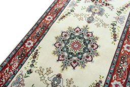 Backside of handmade 2000s Tabriz 50/60/70 Raj rug showing knot structure and weave density
