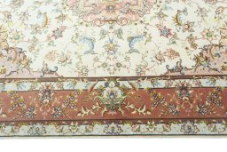 Corner detail of 2000s Tabriz 50/60/70 Raj rug showing border pattern and Cork pile
