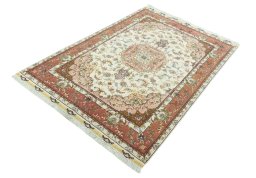Corner detail of 2000s Tabriz 50/60/70 Raj rug showing border pattern and Cork pile