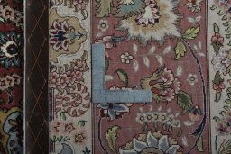 Backside of handmade 2000s Tabriz 50/60/70 Raj rug showing knot structure and weave density