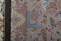 Backside of handmade 2000s Tabriz 50/60/70 Raj rug showing knot structure and weave density