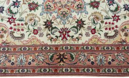 Corner detail of 2000s Tabriz 50/60/70 Raj rug showing border pattern and Cork pile