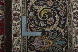 Backside of handmade 2000s Tabriz 50/60/70 Raj rug showing knot structure and weave density