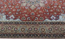 Corner detail of 2000s Tabriz 50/60/70 Raj rug showing border pattern and Cork pile