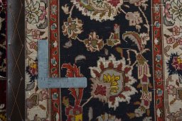 Backside of handmade 2000s Tabriz 50/60/70 Raj rug showing knot structure and weave density