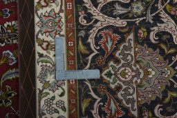 Backside of handmade 2000s Tabriz 50/60/70 Raj rug showing knot structure and weave density