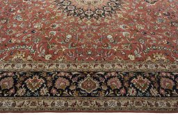 Corner detail of 2000s Tabriz 50/60/70 Raj rug showing border pattern and Cork pile