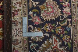 Backside of handmade 2000s Tabriz 50/60/70 Raj rug showing knot structure and weave density