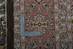 Backside of handmade 2000s Tabriz 50/60/70 Raj rug showing knot structure and weave density