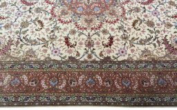 Corner detail of 2000s Tabriz 50/60/70 Raj rug showing border pattern and Cork pile