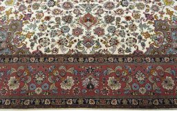 Corner detail of 2000s Tabriz 50/60/70 Raj rug showing border pattern and Cork pile