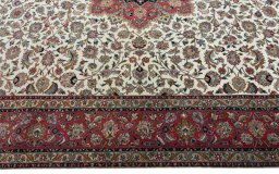 Corner detail of 2000s Tabriz 50/60/70 Raj rug showing border pattern and Cork pile