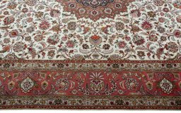 Corner detail of 2000s Tabriz 50/60/70 Raj rug showing border pattern and Cork pile