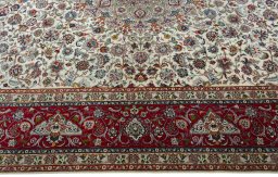 Corner detail of 2000s Tabriz 50/60/70 Raj rug showing border pattern and Cork pile