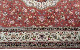 Corner detail of 2000s Tabriz 50/60/70 Raj rug showing border pattern and Cork pile