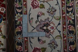 Backside of handmade 2000s Tabriz 50/60/70 Raj rug showing knot structure and weave density