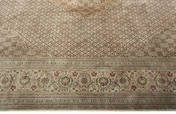 Corner detail of 2000s Tabriz 50/60/70 Raj rug showing border pattern and Cork pile