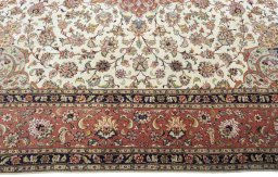 Corner detail of 2000s Tabriz 50/60/70 Raj rug showing border pattern and Cork pile
