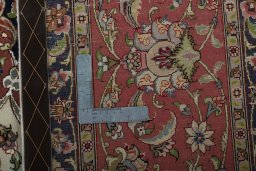 Backside of handmade 2000s Tabriz 50/60/70 Raj rug showing knot structure and weave density