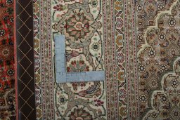 Backside of handmade New Tabriz 50/60/70 Raj rug showing knot structure and weave density