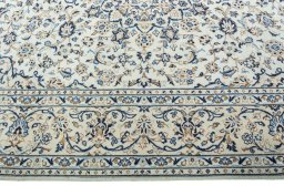 Corner detail of 2000s Kashan rug showing border pattern and Wool pile