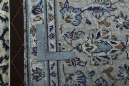 Backside of handmade 2000s Kashan rug showing knot structure and weave density
