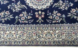 Corner detail of 2000s Nain rug showing border pattern and Wool pile