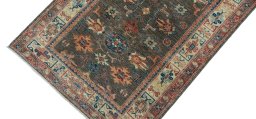 Backside of handmade New Kazak rug showing knot structure and weave density