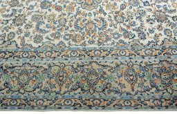 Corner detail of 2000s Yazd rug showing border pattern and Wool pile