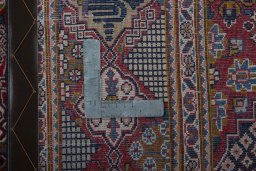 Backside of handmade 2000s Kashan rug showing knot structure and weave density