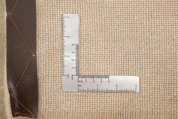 Corner detail of New Organic rug showing border pattern and Wool pile