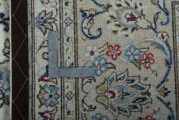 Backside of handmade 2000s Kashan rug showing knot structure and weave density
