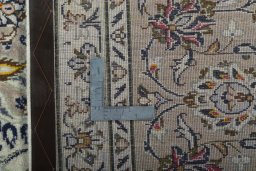 Backside of handmade 2000s Kashan rug showing knot structure and weave density