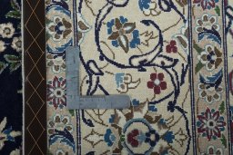 Backside of handmade 2000s Nain rug showing knot structure and weave density