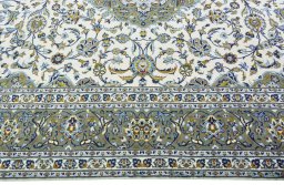 Corner detail of 2000s Kashan rug showing border pattern and Wool pile