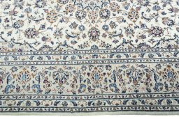 Corner detail of 2000s Kashan rug showing border pattern and Wool pile