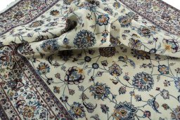 Surface texture of 2000s Mashad rug with natural Wool and intricate pattern