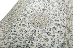 Backside of handmade 2000s Kashan rug showing knot structure and weave density