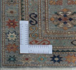 Corner detail of New Kazak rug showing border pattern and Wool pile