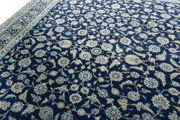 Backside of handmade 2000s Kashan rug showing knot structure and weave density