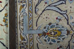 Backside of handmade 2000s Kashan rug showing knot structure and weave density