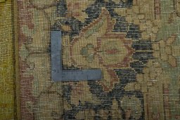 Backside of handmade 1950s Vintage rug showing knot structure and weave density