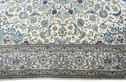 Corner detail of 2000s Nain rug showing border pattern and Wool pile