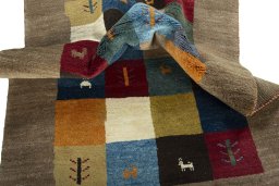 Corner detail of 2000s Persian Gabbeh rug showing border pattern and Wool pile