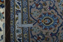 Backside of handmade 2000s Kashan rug showing knot structure and weave density