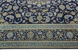 Corner detail of 2000s Kashan rug showing border pattern and Wool pile